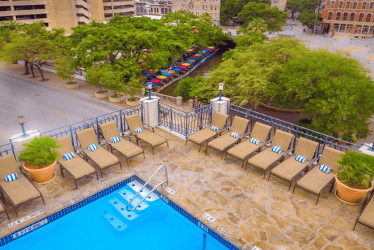 Outdoor pool with sun loungers.