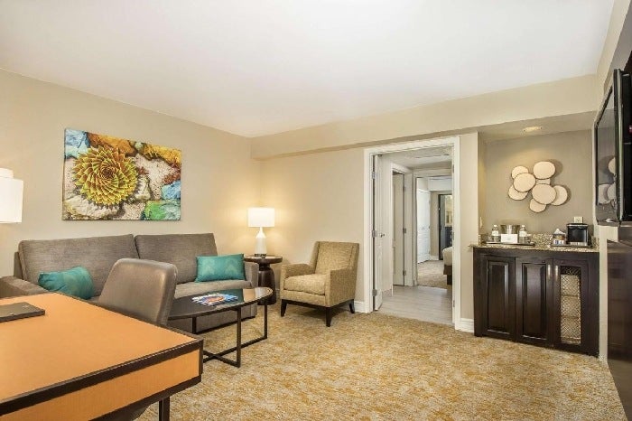 Seating area, and a flat screen TV inside a guest room.