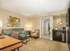 Seating area, and a flat screen TV inside a guest room.
