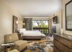 One King bed, a balcony, and a flat screen TV inside a guest room.