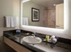 Fresh towels and complimentary toiletries inside a private bathroom.