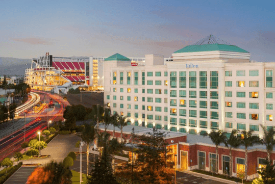 Hotel exterior at dusk.