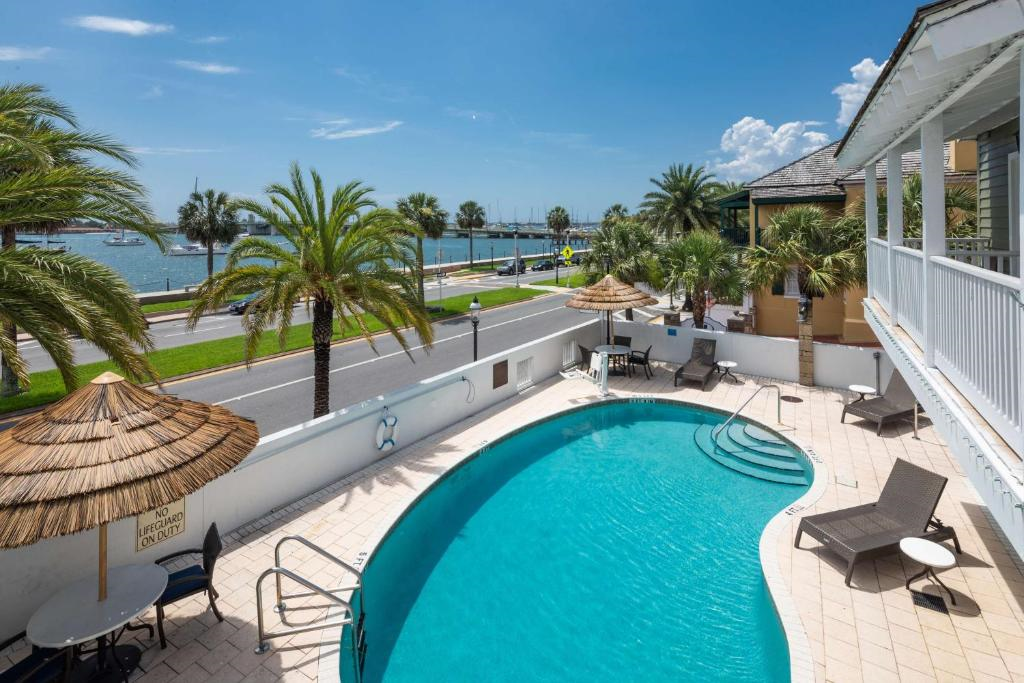 Relax by the waterfront pool at Hilton St. Augustine Historic Bayfront, with scenic views of the Matanzas Bay and swaying palm trees.