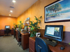 Business center with ergonomic chairs, desks, and computers.