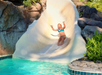 Outdoor pool with fun waterslide.