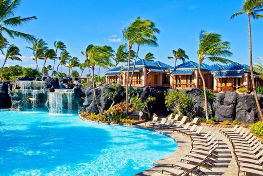 Refreshing outdoor pool with poolside chairs and swaying palm trees.