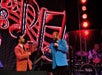 Men in suit jackets sing during Hit Parade