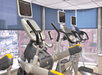 Three ellipticals in front of large window looking down on the city of Denver at the Holiday Inn Express Denver Downtown.