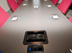 A conference table with built in electrical and bright red office chairs surrounding it at the Holiday Inn Express & Suites in Columbus.