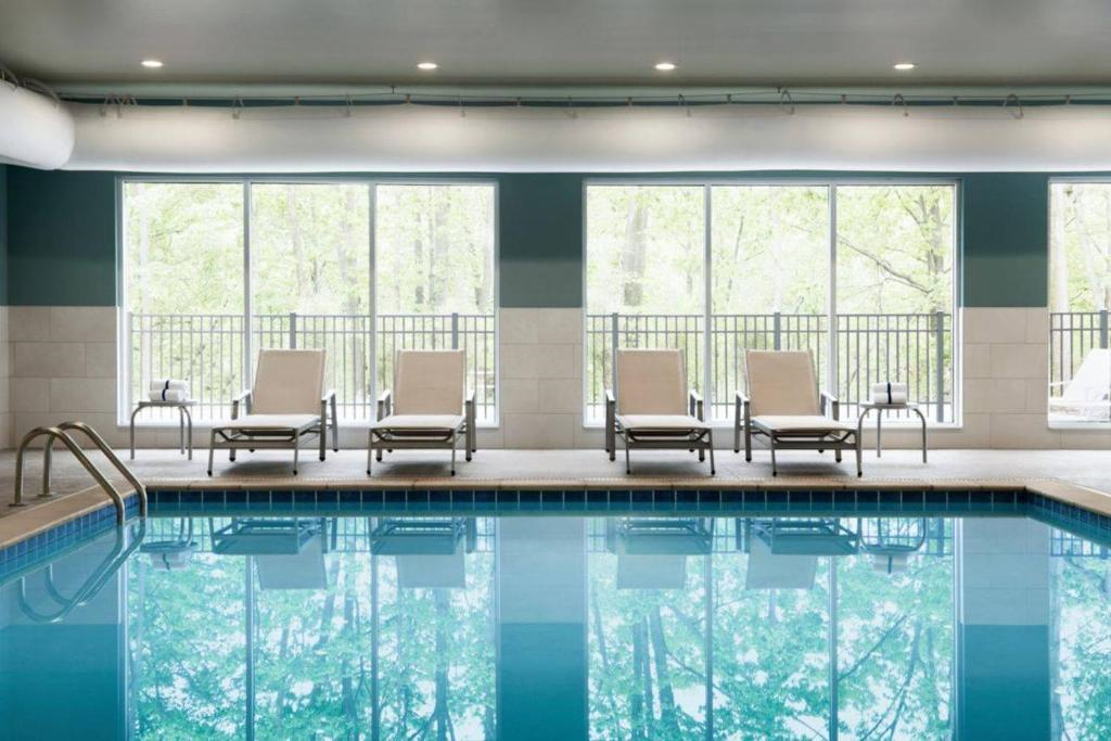 Indoor pool with lounge chairs.