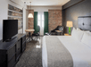 One king bed, work desk and a flat-screen TV inside a non-smoking room.