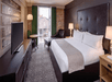 One king bed, work desk, and a flat-screen TV inside a non-smoking room.