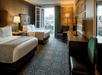 Two double beds and a flat-screen TV inside a non-smoking room.