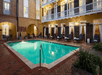 Outdoor pool surrounded by sun loungers and private balconies