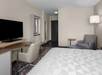 1 King bed, sofa chair, flat-screen TV at Holiday Inn Hasbrouck Heights-Meadowlands, an IHG Hotel, NJ.