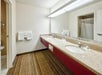 Fresh towels and bathroom amenities inside a private bathroom.
