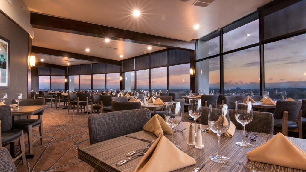 Dine in style at the restaurant on property offering panoramic view of the city.