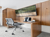 Work desk and ergonomic desk chair, with a Keurig coffee maker.