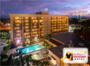 Aerial view of the hotel and the pool area at night.