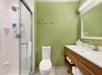 Guest bathroom with lighted mirror, toilet and sink.