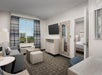 One King bed, a work desk and chair, seating area/sofa and a flat screen TV.