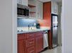 Fully-equipped kitchen with microwave, refrigerator, and dishwasher.