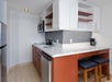 Fully-equipped kitchen with microwave, refrigerator, and dishwasher.