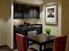 Kitchenette, dining table, microwave, stovetop, dishwasher at Homewood Suites by Hilton Toronto Vaughan, ON.