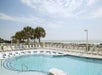 Outdoor pool with a view of the beach.