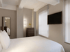 One King bed and a flat-screen TV inside a guest room.