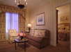 Beautifully decorated living area with a sofa and an arm chair.