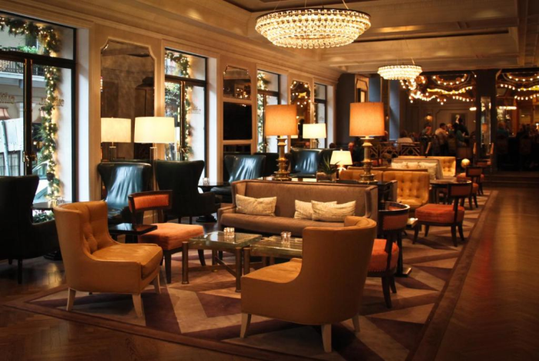 Dining area with modern furniture, and lighting fixtures.