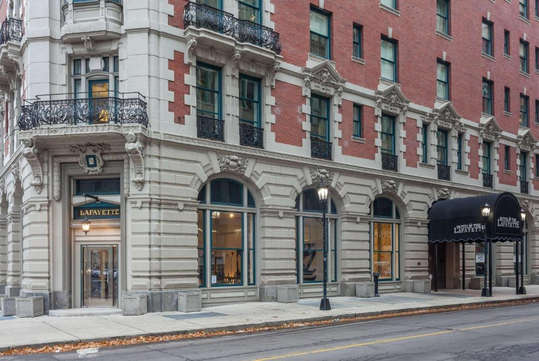 Historic red and white brick hotel with ornate detailing, large windows, and a black awning over the entrance reading "Lafayette.
