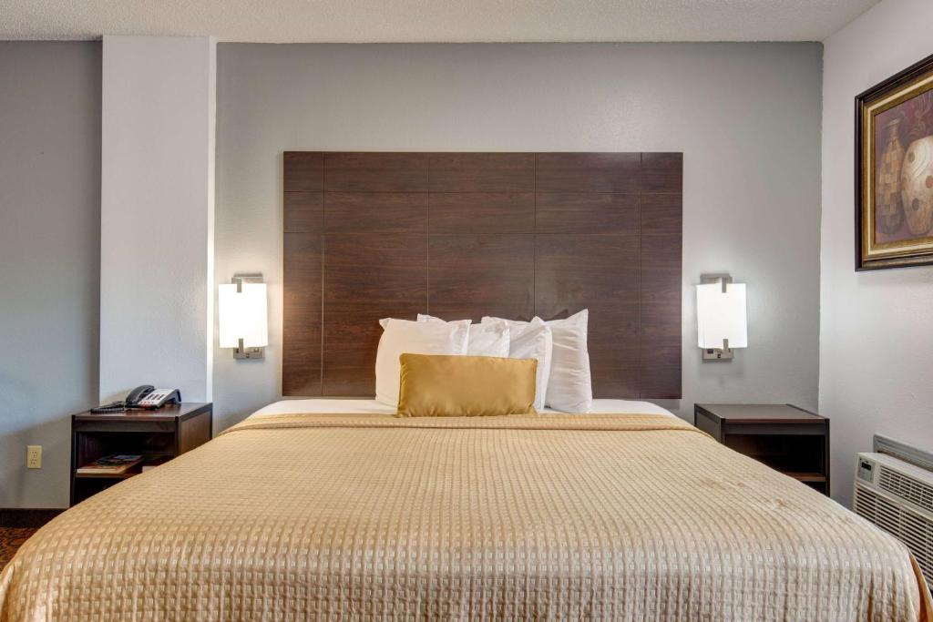 A king bed, a telephone and nightstands inside a guest room.