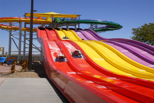 Adrenaline-pumping race down colorful water slides.