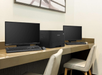 Business center with two computers and a printer.