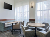 Lobby seating area with sofa, chairs and a flat-screen TV.