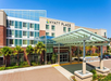 Exterior view of a Hyatt Place hotel with a modern entrance and glass canopy.