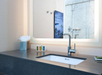 Single vanity mirror with bathroom amenities in a private bathroom.
