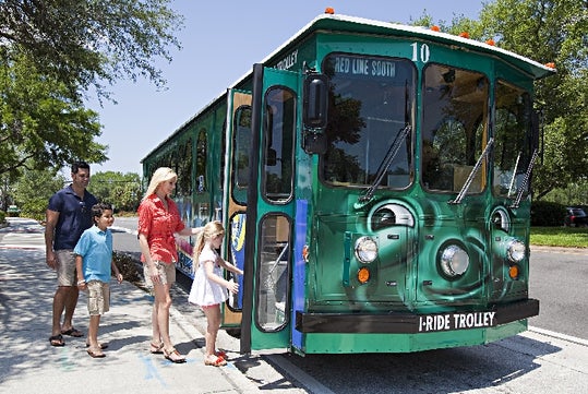 Family boarding in an I-Ride Trolley.