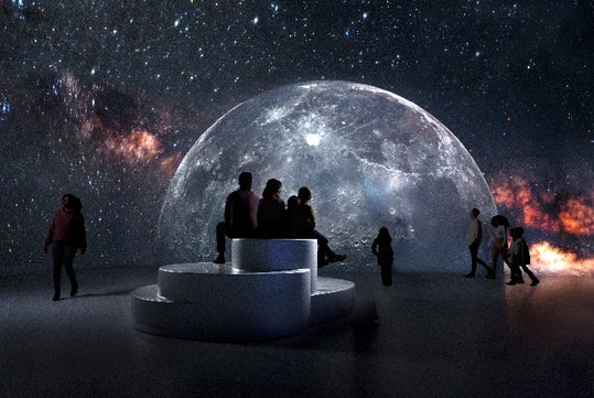 People enjoying the Illuminarium display of the moon in Atlanta, Georgia.
