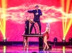 Rick Thomas stands on top of a table for an illusion with women in red dress at his Mansion of Dreams Show in Branson, Missouri.