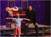 Rick Thomas with his assistant and a kid from the audience doing a magic trick
