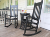 Balcony with an outdoor table and rocking chairs