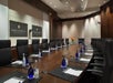 A conference room with a large table surrounded by chairs, notepads, pens, and bottles of water. Two large signs on the wall display "InterContinental Toronto Centre.