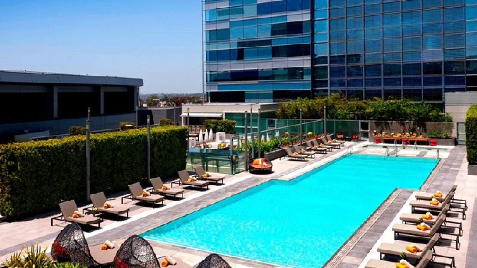 Outdoor pool with sun loungers.