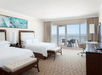 2 Queen beds and a private balcony inside a guest room at JW Marriott Marco Island Beach Resort, FL.