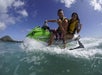 A couple having fun together while riding a jetski.


