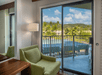 Guest room with seating area and balcony.