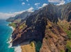 Sharp mountain ranges seem from the ocean with small beach areas on the Kauai Eco Adventure Helicopter Tour in Hawaii USA.